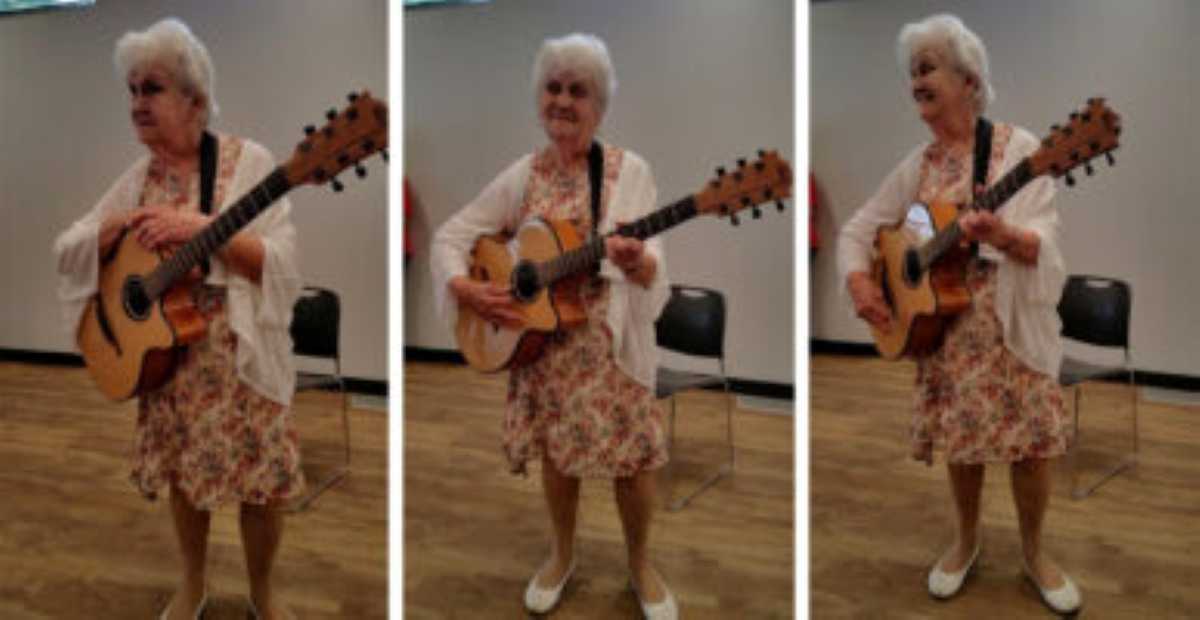 Three photos side by side showing a joyful elderly woman in a floral dress and white cardigan playing a guitar. She is standing in a room with a wooden floor and smiling as she performs.