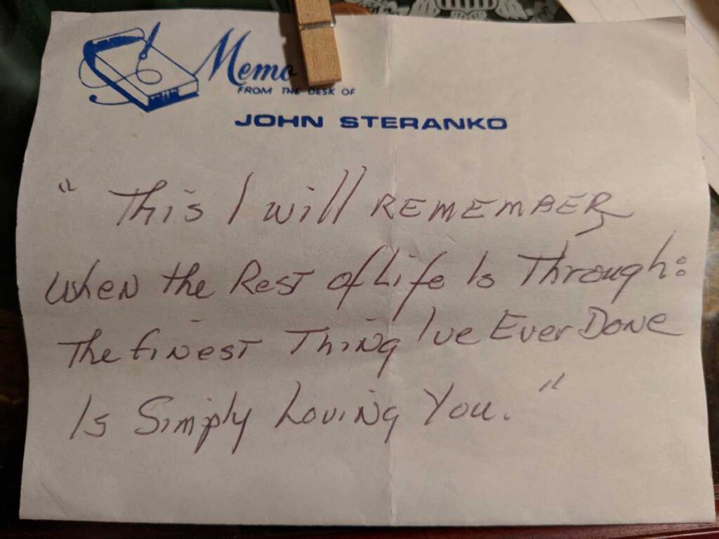 A full handwritten note on memo paper labeled “From the Desk of John Steranko,” reading: "This I will remember when the rest of life is through: The finest thing I've ever done is simply loving you."