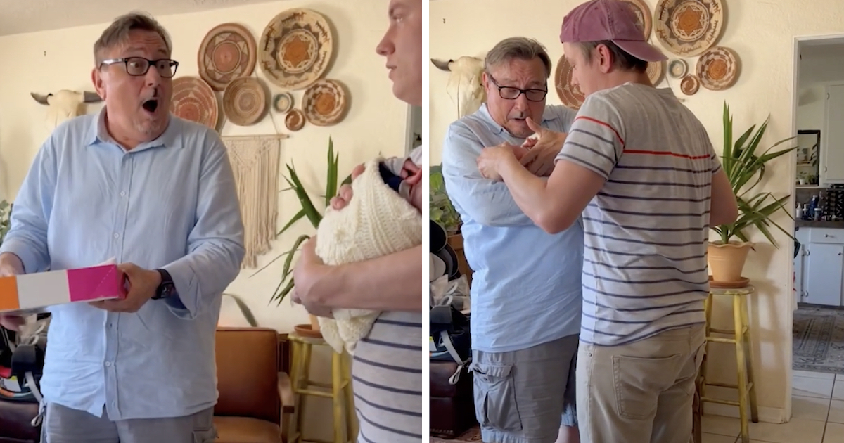 A man wearing glasses and a light blue shirt reacts with joyful surprise while holding a pink and orange box, facing another man cradling a newborn in a white knitted blanket. In the next frame, the older man gently touches the baby’s hand with emotion while the younger man helps him hold the infant in a cozy, warmly decorated living room.