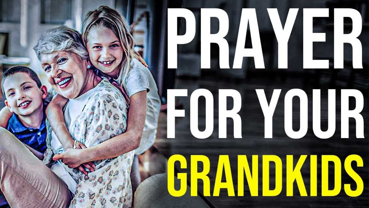 Smiling older woman sits joyfully with a young boy and girl hugging her from both sides. The background is a cozy indoor setting. Bold white and yellow text on the right reads, "PRAYER FOR YOUR GRANDKIDS."