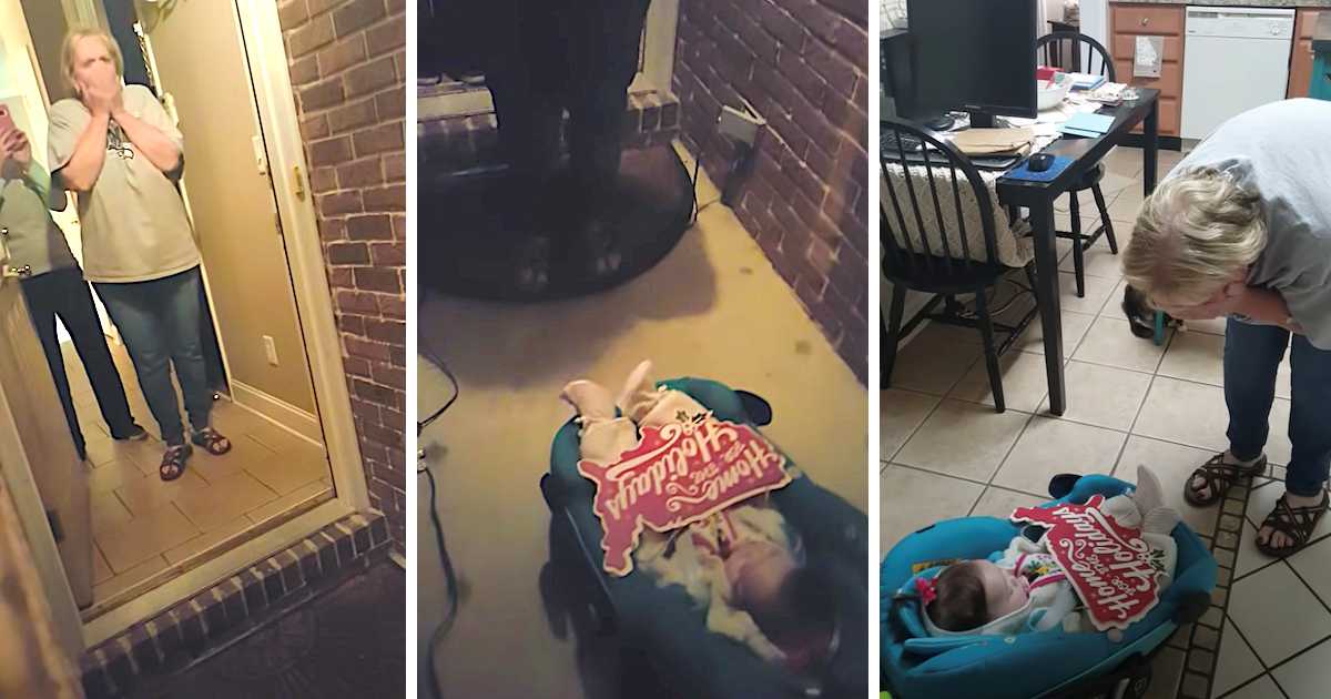 Emotional woman reacts to surprise visit, seeing a baby in a carrier with a “Home for the Holidays” sign at the door and inside the home.