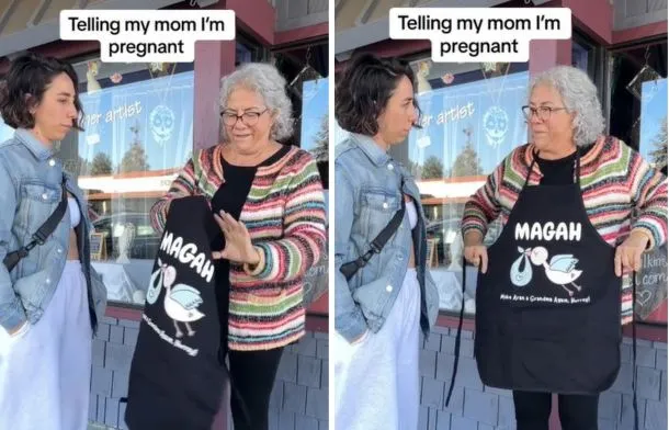 Mother looks delighted while holding up and then wearing a custom apron labeled “MAGAH.”