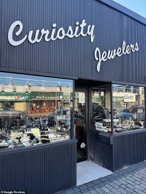 101-year-old woman who still goes to work 6 days a week shares her life advice 5 Storefront of Curiosity Jewelers, featuring display windows filled with jewelry and a reflection of the street outside.