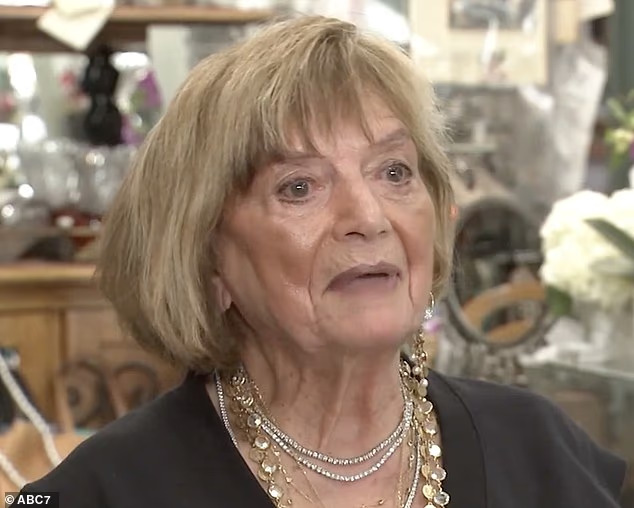 101-year-old woman who still goes to work 6 days a week shares her life advice 2 Close-up of an older woman wearing layered gold and pearl necklaces, speaking inside a jewelry shop.