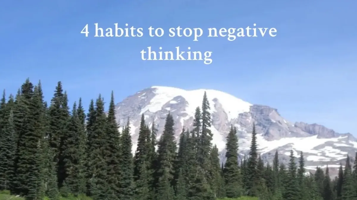 Text reading “4 habits to stop negative thinking” over a scenic view of snow-capped mountains and pine trees.