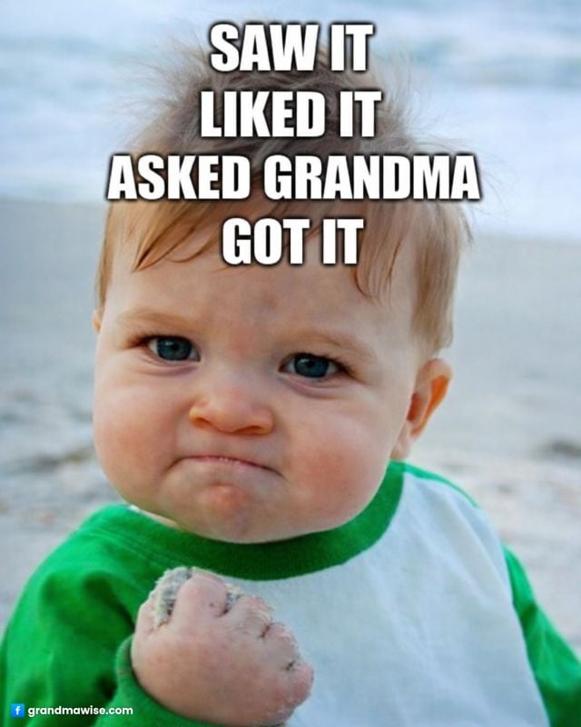 12 Things Grandparents Do That Should Never Be Taken for Granted 6 A determined-looking toddler with a clenched fist on a beach, humorously implying that asking grandma guarantees getting something they want.