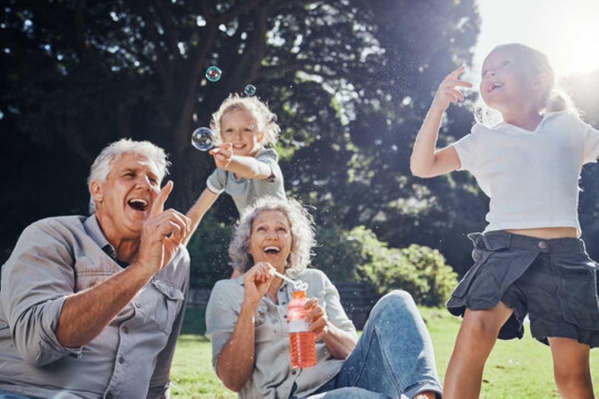 Grandparents having fun with grandkids outdoors.